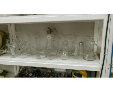 A shelf of glassware inluding claret jug & vases etc.