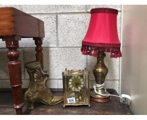 A mantle clock, a brass table lamp and a brass boot