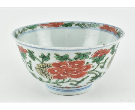 A possibly Ming dynasty ceramic bowl. The bowl painted in red, green and yellow enamels with flowering peonies, chrysanthemum