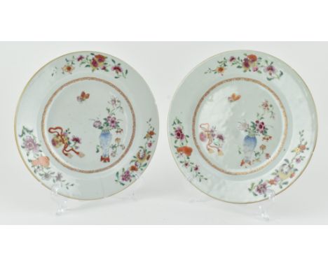 A pair of 18th century Qing dynasty Yongzheng period famille rose ceramic ogee plates. Each plate decorated with pomegranate,