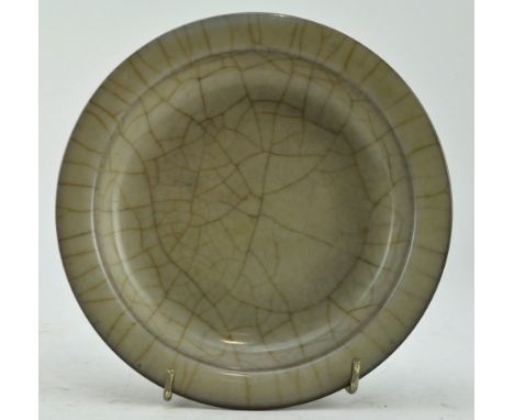 A Qing dynasty &lsquo;Ge&rsquo;-type plate, covered overall with a greyish-cream glaze with a dense network of dark brown cra