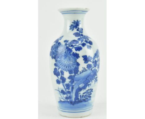 A 18th century Qing dynasty Kangxi period blue and white ceramic miniature vase. The flared rim vase decorated with chrysanth