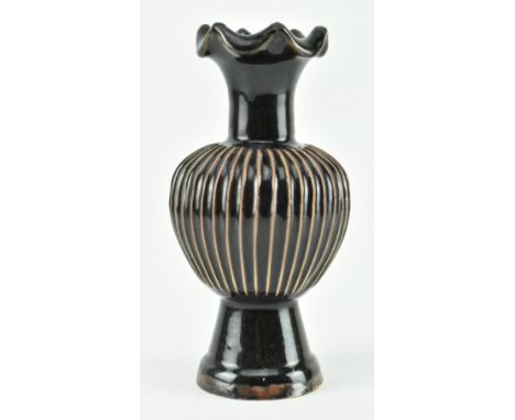 A Northern Song style black glazed Cizhou ribbed vase. The vase potted with lobed bulbous body rising to a trumpet neck and a