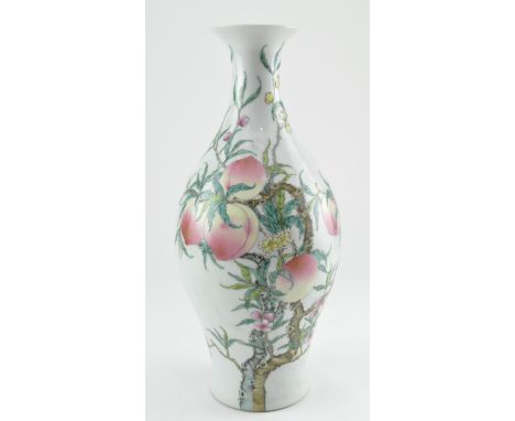 A Qing dynasty famille rose olive shaped ceramic "ganlanping" vase. The vase has a flared rim decorated with eight peaches wi