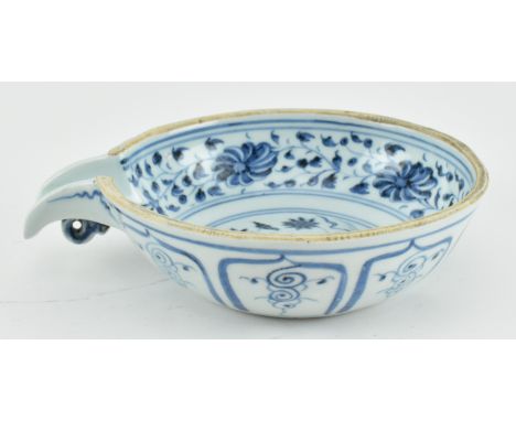 A Yuan dynasty or later blue an white ceramic pouring bowl. The rounded sides resting on a slightly concave base, one side se