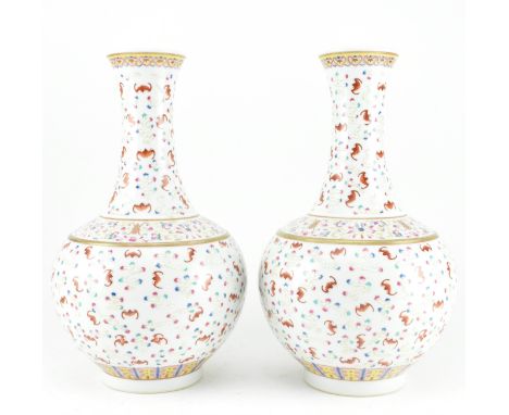 A pair of 20th century famille rose "Bats and Clouds" ceramic bottle vases. Each vase is delicately painted with iron-red bat