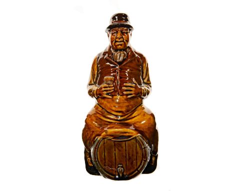 Doulton Kingsware glaze of Bacchus sitting on a whiskey barrel, also known as Man on Barrel or called the Landlord Flask. The