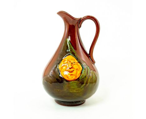 Rich, dark brown glaze; pear shaped form. Depicts portrait of the monk in a green clock.Marked Dewar's Scotch Whisky on rever