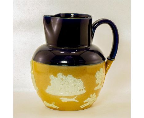 Two-tone blue and caramel pitcher with scenes in low-relief.Impressed Royal Doulton. #royaldoulton Issued: 20th c.Dimensions: