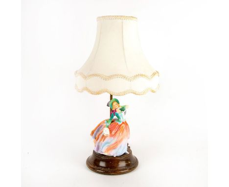 Doulton lamp with the Harradine Classics figure, Autumn Breezes mounted on wooden base.Age and use related wear; wear to shad