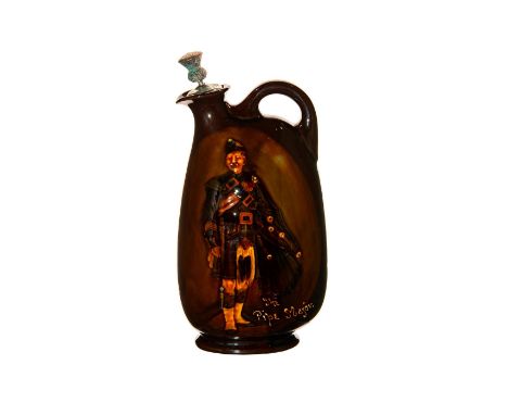 A Dewar's whiskey flask in Kingsware glaze with a pipe major - leading military pipe band. Text reads "The Pipe Major." Origi