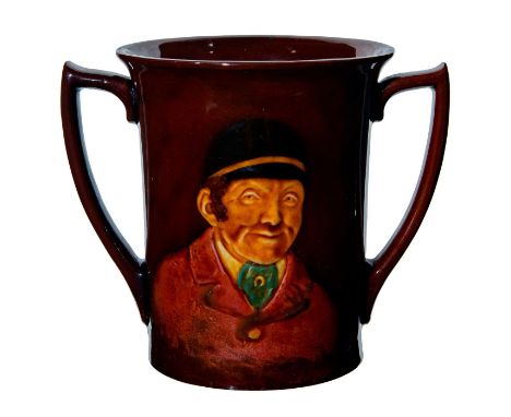 Dark brown glaze with relief portrait of hunter. Scene of hounds on backside.Royal Doulton backstamp. Age related crazing. Is
