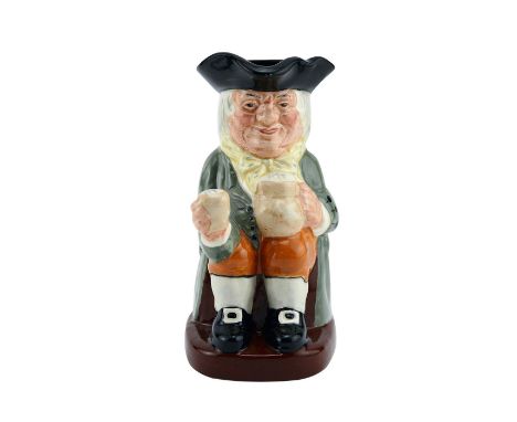 Glossy porcelain; hand decorated with black hat, light green coat with yellow scarf with blue polka dots.Royal Doulton backst
