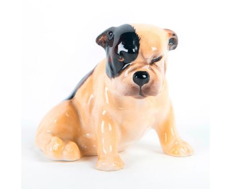 Seated puppy, tan with dark brown patches.Brown face patch can either be on the left or right side. Royal Doulton backstamp. 