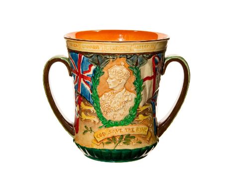 This loving cup features a profile of George VI in coronation regalia with the legend GOD SAVE THE KING belowOn either side a