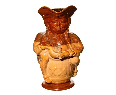 Extra large size Toby jug, seated on barrel, holding jug. Shaded dark brown glaze on top and bottom, lighter brown in the cen