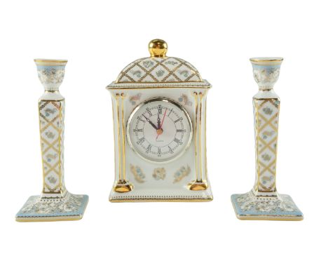 A Past Times mantle clock together with a pair of conforming candlesticks, clock 20 cm