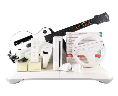 A Nintendo Wii video games console together with a group of accessories, including a Wii fit board, a Guitar Hero guitar cont