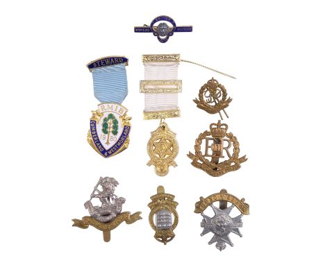 A Royal Arch Masonic jewel together with a RMIB 1980 steward jewel, a small group of British Army cap badges, etc