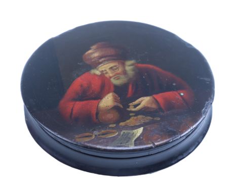 An early 19th Century hand painted circular mache snuff box depicting a bearded man counting money, gilt interior, 10.5 x 2 c
