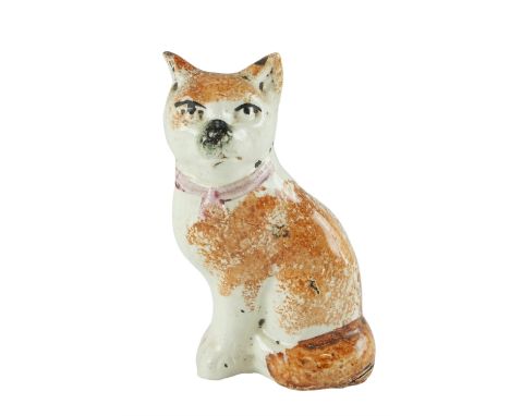 A Victorian Staffordshire earthenware model of a seated cat, 13 cm high