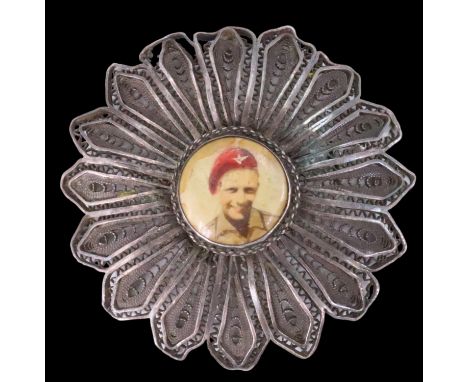 A 1940s white metal filigree brooch bearing an inset portrait photograph of a Parachute Regiment soldier, stamped "Made in Pa