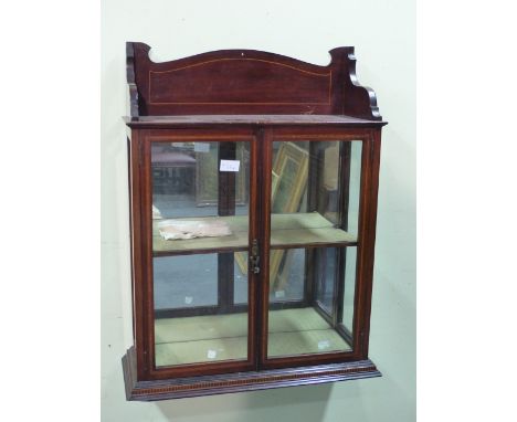 AN EDWARDIAN MAHOGANY WALL CABINET. THE SHELF TOP OVER SATIN WOOD BANDED GLAZED DOORS ENCLOSING TWO SHELVES.   W 53 x D 19.5 