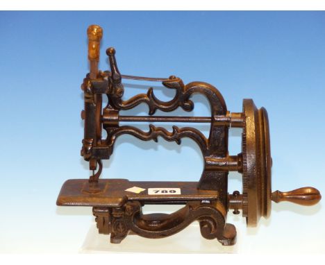 A 19th.C.CAST IRON FRAMED MINIATURE SEWING MACHINE, UNSIGNED BUT POSSIBLY THE GLOBE BY JAMES WEIR, SOHO.