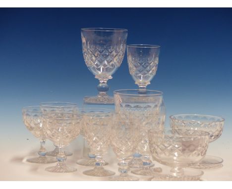 A TUDOR CLEAR GLASS DRINKING SET, EACH PIECE CUT WITH A BAND OF ROUNDELS ABOVE DIAMOND DIAPER AND STAR CUT FOOT.