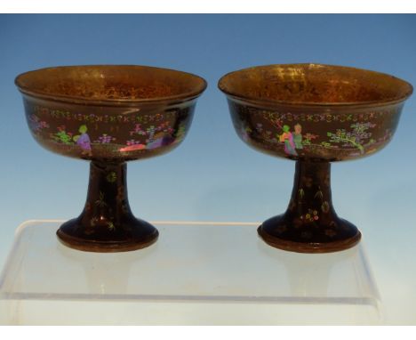 A PAIR OF CHINESE LAC BURGAUTE STEM CUPS, THE BLACK EXTERIORS INLAID WITH MOTHER OF PEARL FIGURES IN FENCED GARDENS, THE INTE