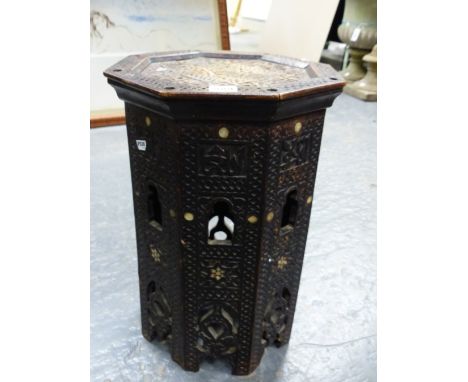 AN ISLAMIC OCTAGONAL TABLE, THE DISHED TOP AND SIDES INSCRIBED IN RELIEF, THE LATTER PIERCED WITH OGEE ARCHES ABOVE MOTHER OF