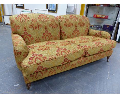 A  BESPOKE HOWARD STYLE DEEP SEAT SETTEE UPHOLSTERED IN JIM DICKENS FABRIC WITH FEATHER FILLED CUSHIONS SANDING ON RING TURNE