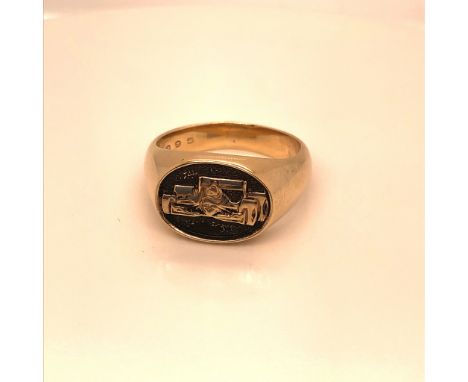 A REYNARD YELLOW METAL SIGNET RING, COMPLETE WITH RACING CAR ENGRAVING TO THE HEAD, ENGRAVED INSIDE SHANK THANKS RYAN,INDY 19