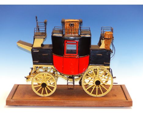 A MICHAT BOGAJEWICZ SCALE MODEL MAIL COACH WITH RED BODY AND YELLOW WHEELS, A WICKER BASKET CENTRAL TO THE BLACK SEATING ON T