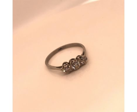 A PLATINUM AND THREE STONE RING. THE GRADUATED STONES HELD IN A CLAW SETTING ON A PLAIN POLISHED SHANK. FINGER SIZE Q. WEIGHT