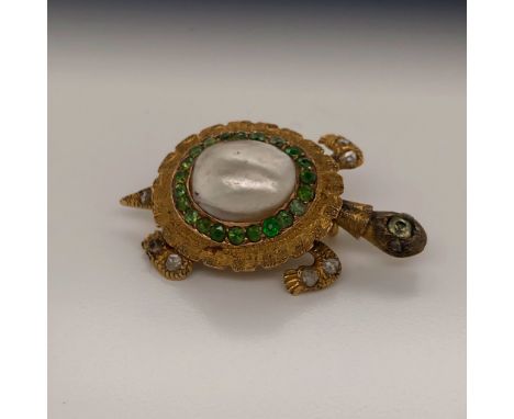 A YELLOW METAL GEMSET TORTOISE BROOCH. THE SHELL SET WITH A BAROQUE PEARL SURROUNDED BY A HALO OF EMERALDS,THE ARTICULATED AP