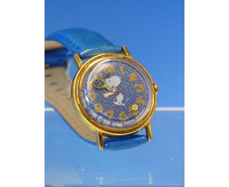 A VINTAGE MANUAL WOUND SNOOPY WRIST WATCH FEATURING SNOOPY PLAYING TENNIS WITH A TENNIS BALL SECONDHAND AND TENNIS RACKET MIN