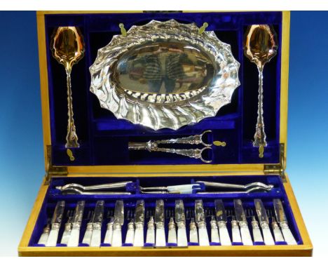 AN OAK CANTEEN OF FRUIT AND NUT EATING ELECTROPLATE BY E J FAIRBAIRNS, COMPRISING TWELVE MOTHER OF PEARL HANDLED FRUIT KNIVES