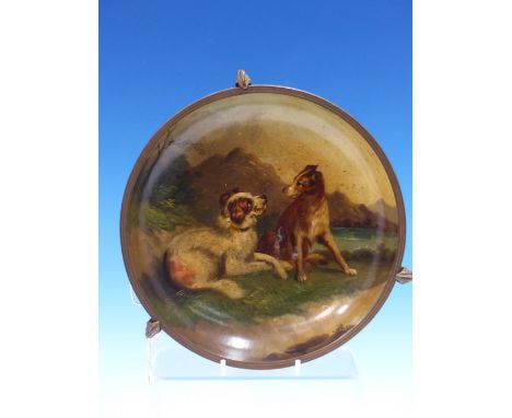 A PAPIER MACHE DISH PAINTED WITH TWA DOGS (sic) PLAYING BESIDE A LOCH, THE RIM METAL MOUNTED AND FITTING INTO A TRIPOD STAND 