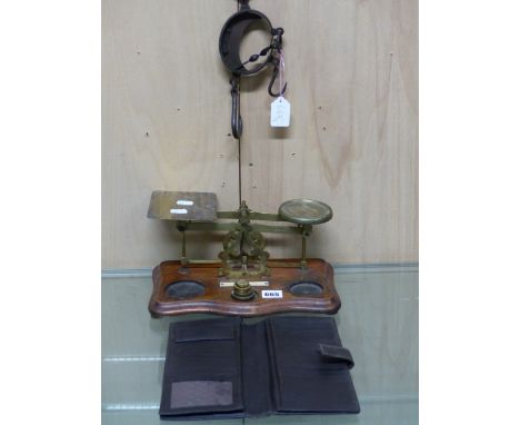 A SET OF BRASS POSTAL SCALES, THE SERPENTINE FRONTED MAHOGANY BASE.   W 30cms. A LEATHER WALLET TOGETHER WITH AN IRON SCISSOR