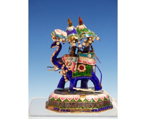 TWO INDIAN ENAMEL ELEPHANTS BEARING JEWELLED HOWDAHS AND WALKING ON STYLISED LOTUS FLOWER BASES.   H 15 and 7cms