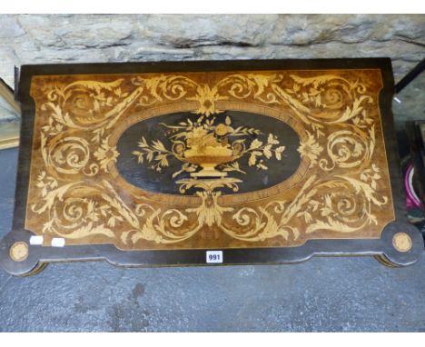 A FRENCH MARQUETRY SWIVEL TOP GAMES TABLE, THE CENTRAL VASE OF FLOWERS OVAL WITHIN FOLIAGE ON A YEW WOOD GROUND, EBONY BAND A