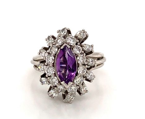 A PLATINUM AMETHYST AND DIAMOND CLUSTER RING. THE CENTRAL MARQUIS CUT AMETHYST SURROUNDED BY A HALO OF BRILLIANT CUT DIAMONDS