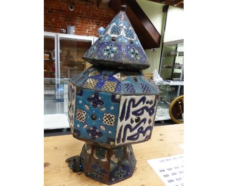 AN ISLAMIC TURQUOISE ENAMELLED AND JEWELLED OCTAGONAL LANTERN PIERCED WITH PANELS OF BLUE AND WHITE SQUARES AND CROSSES ALTER