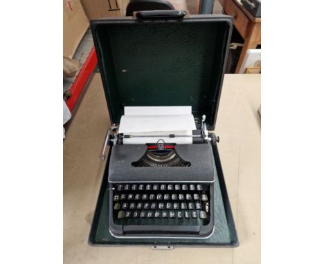 A vintage Olympia typewriter in case. 