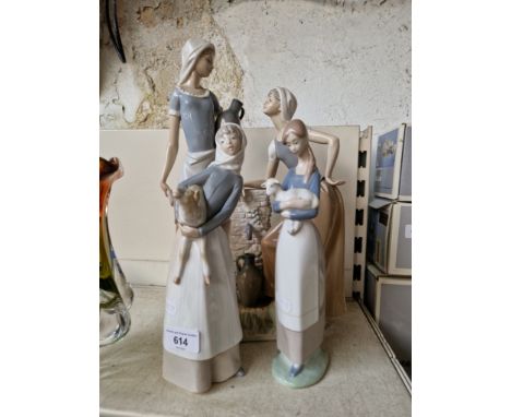 A large Nao figurine 'Talking' and two Lladro figurines. 