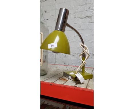 A mustard colour anglepoise lamp. 