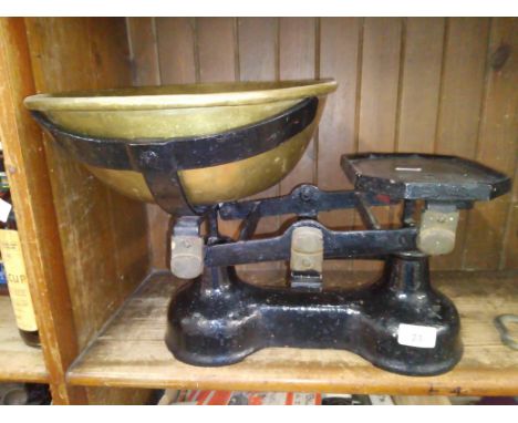 A cast metal weighing scales with bras tray and weights. 