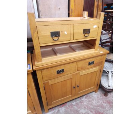 A light oak cabinet and TV stand. 