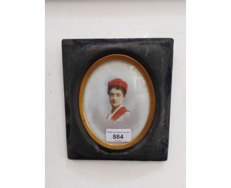 A 19th century miniature portrait on porcelain (10cm x 12.5cm), indistinctly signed to lower right, framed and glazed (16.5cm